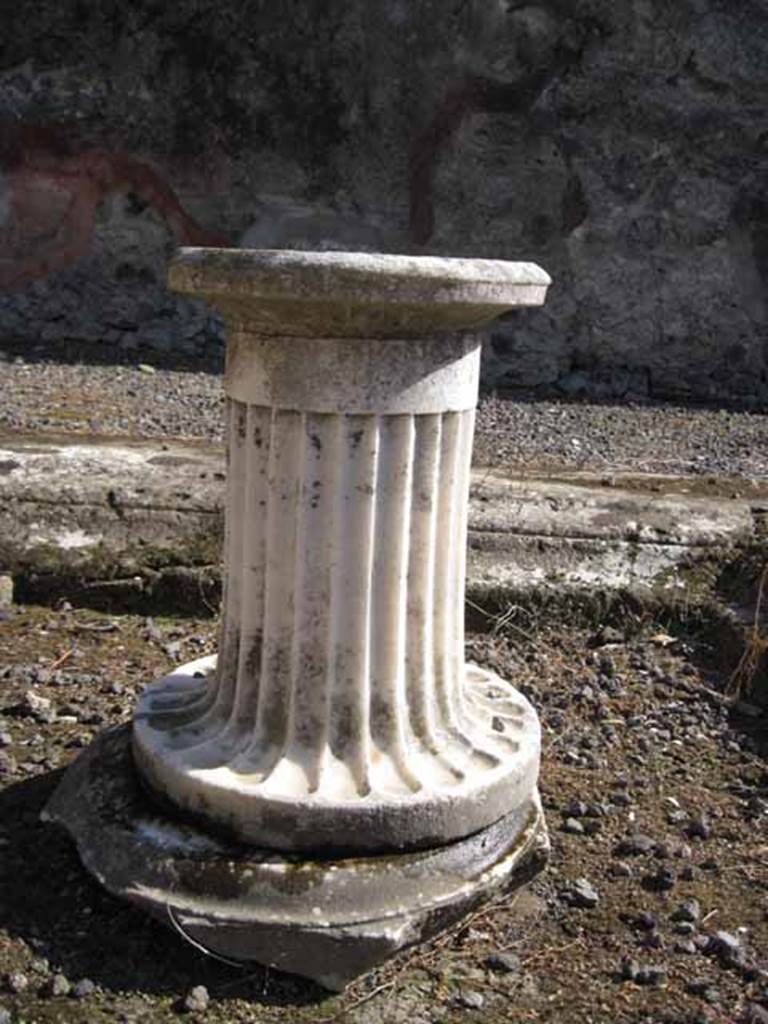 I.2.10 Pompeii. September 2010. Detail of marble monopodium, currently in impluvium. Photo courtesy of Drew Baker.
