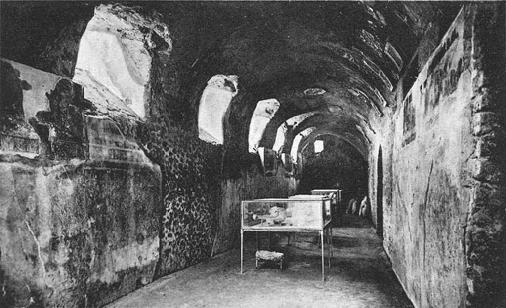 I.6.2 Pompeii. Old photograph c. 1920 of Cryptoporticus with body casts in glass cases.
Looking west along north wing.
