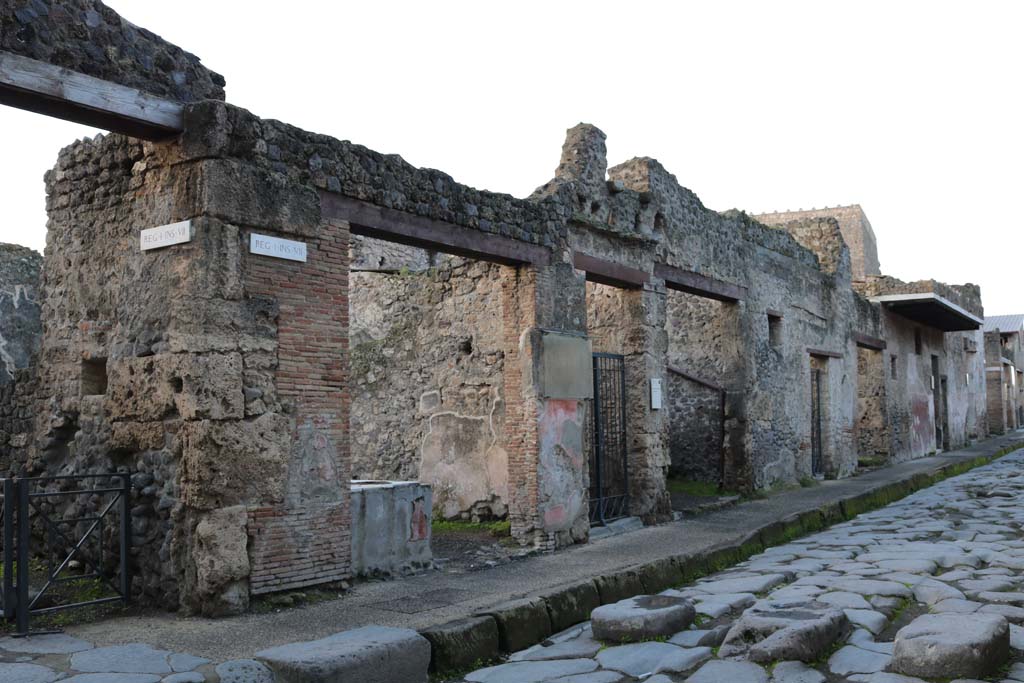 I.7.8 to I.7.1, Pompeii. December 2018. Entrance doorways on south side of Via dellAbbondanza. Photo courtesy of Aude Durand.