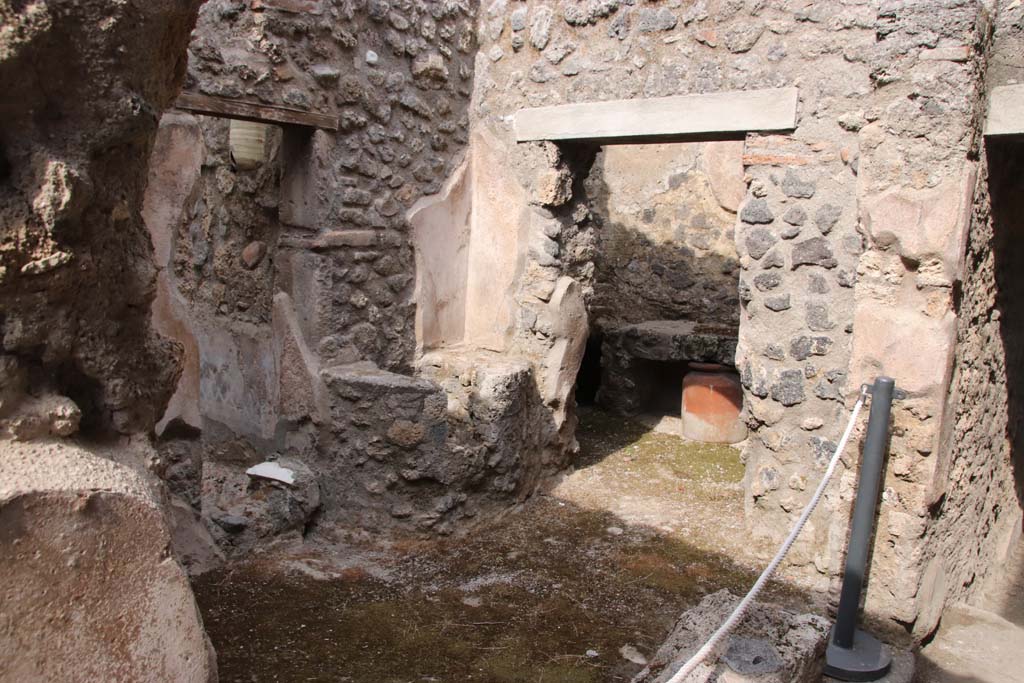 I.7.19 Pompeii. September 2021. 
Small room on north side of corridor with two doorways, one to garden area, the other to kitchen. Photo courtesy of Klaus Heese.
