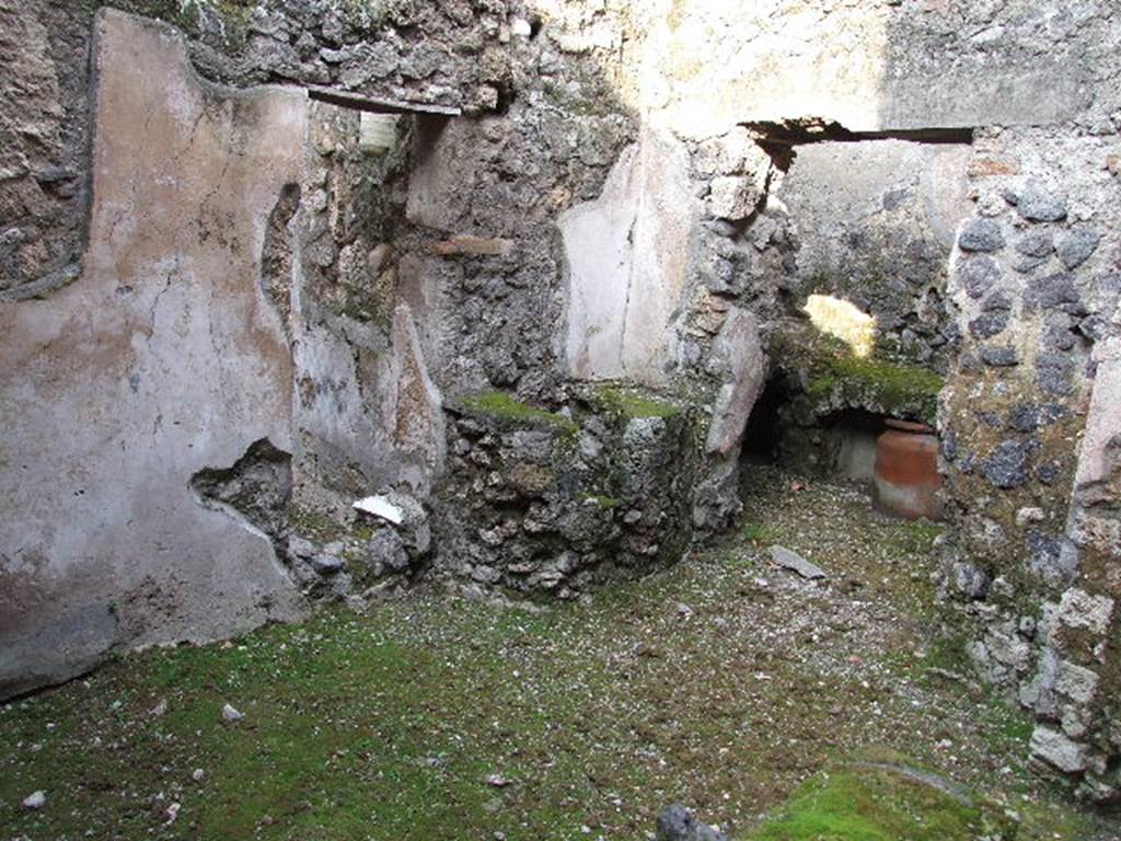 I.7.19 Pompeii. December 2006. Second small room on north side of corridor, doorways to small garden at rear of tablinum, and kitchen area.