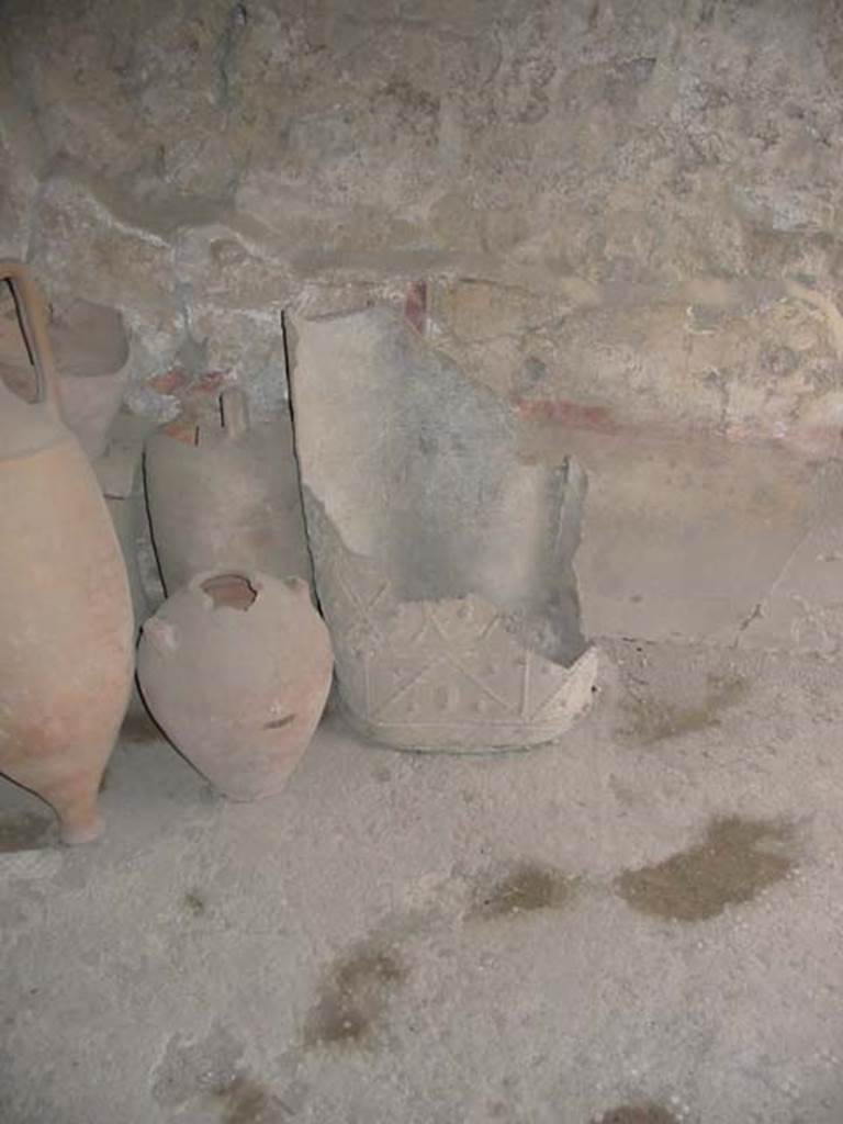 I.8.9 Pompeii. May 2003. Room 4, decorated lead bucket or puteal and terracotta items in room. 
Photo courtesy of Nicolas Monteix.
