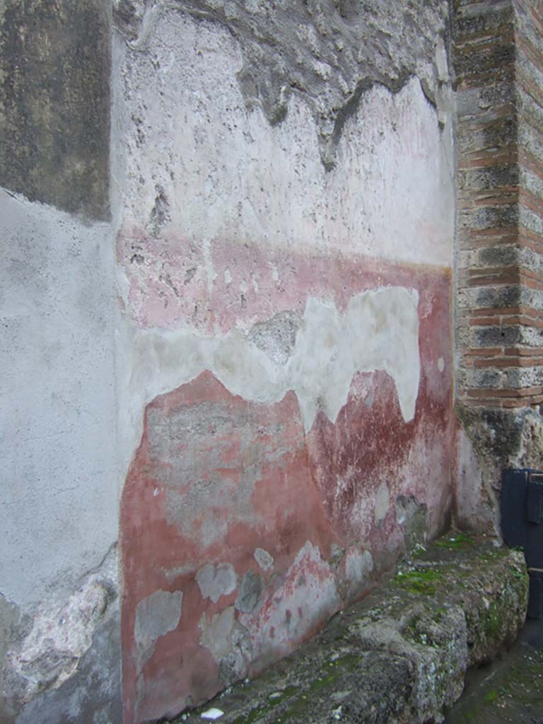 I.10.4 Pompeii. December 2005. Painted plaster on front wall to right of entrance, and faded graffiti.