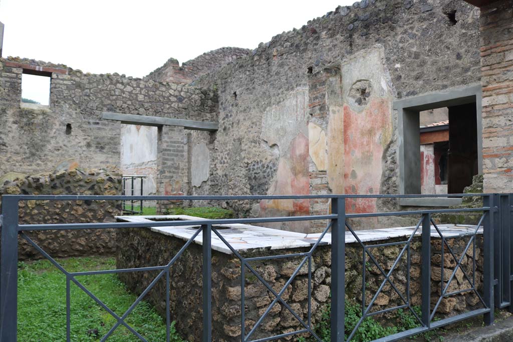 II.4.7 Pompeii. December 2018. 
Looking south-west across bar-room from entrance on Via dell’Abbondanza. Photo courtesy of Aude Durand.
