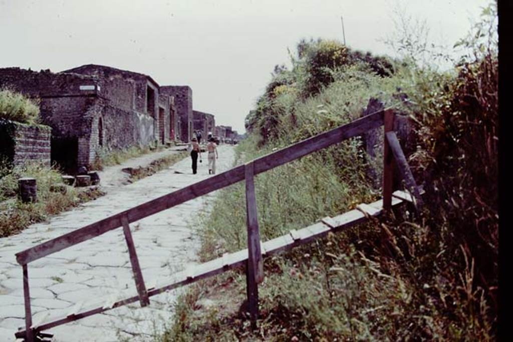 III.7 Pompeii. 1976. Looking west along Via dellAbbondanza. The ramp was built as the only way up and over into the walled site. Photo by Stanley A. Jashemski.   
Source: The Wilhelmina and Stanley A. Jashemski archive in the University of Maryland Library, Special Collections (See collection page) and made available under the Creative Commons Attribution-Non Commercial License v.4. See Licence and use details. J76f0354

