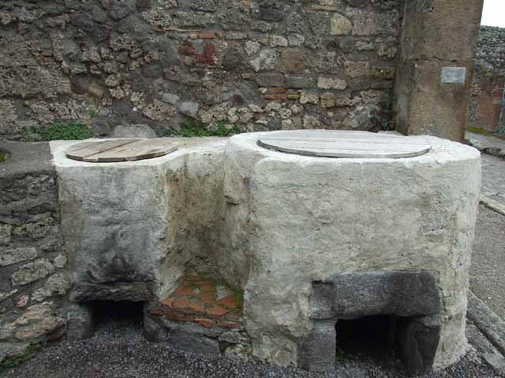 V.1.4 Pompeii. May 2010. Two large renovated boilers or kettles on east side.