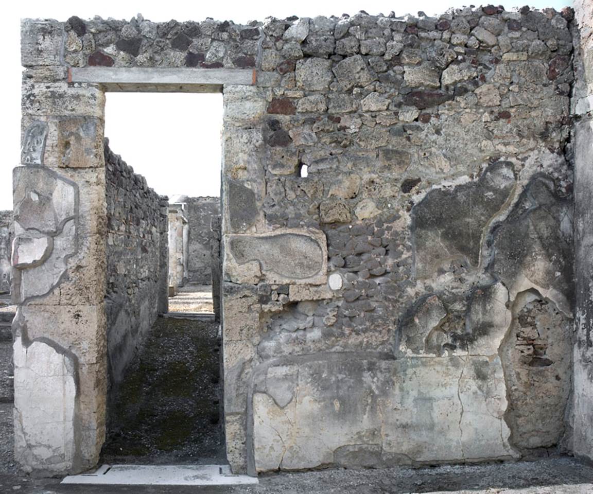 V.1.7 Pompeii. c.2005-7. 
Room 9, north wall of east ala, with doorway to corridor 10 leading to peristyle “b”.
Photo by Hans Thorwid. 
Photo courtesy of the Swedish Pompeii Project. 
