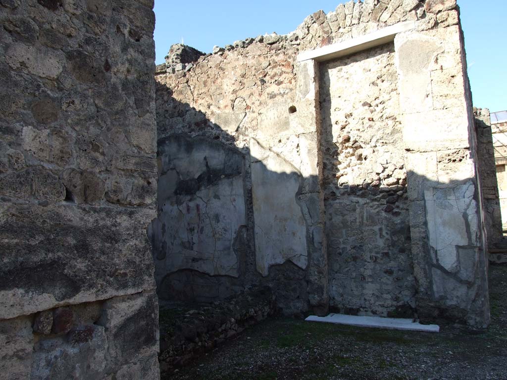 V.1.7 Pompeii. March 2009. Large room on east side of peristyle. Photo taken through hole in wall from room 16.
Room on south side of V.1.9, looking north, towards two doorways.
