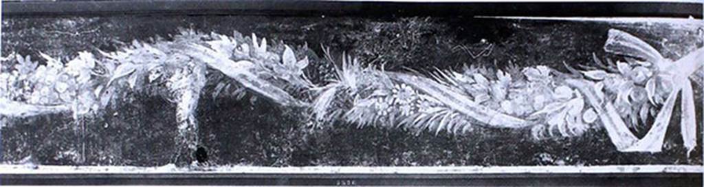V.1.18 Pompeii. Old undated photograph. Tablinum “g”, south wall. Fresco with ribbon wound in a garland and cupid.
Now in Naples Archaeological Museum. Inventory number 8526.
