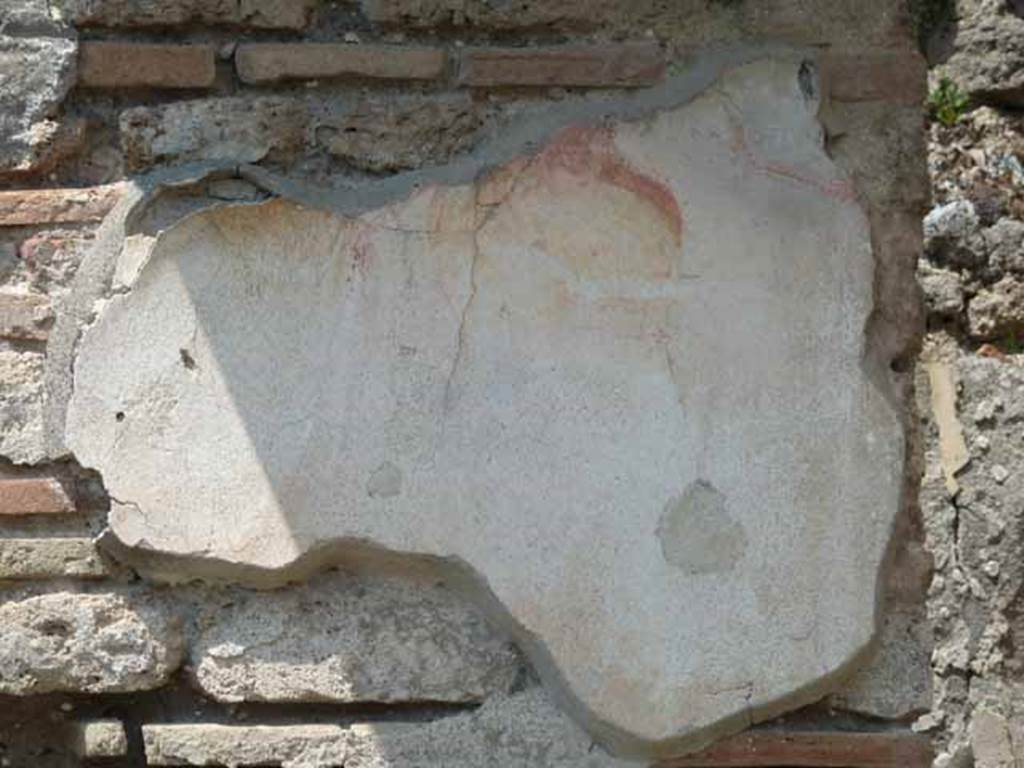 V.4.7 Pompeii. May 2010. Remains of painted plaster on pilaster at rear of bar room behind counter. According to Stefani, there was a small painting of Bacchus and Silenus on the wall in the room.  See: Stefani, G, curatore, 2005. Cibi e Sapori a Pompei e dintorni. Pompei: edizione Flavius. (p.101-2)