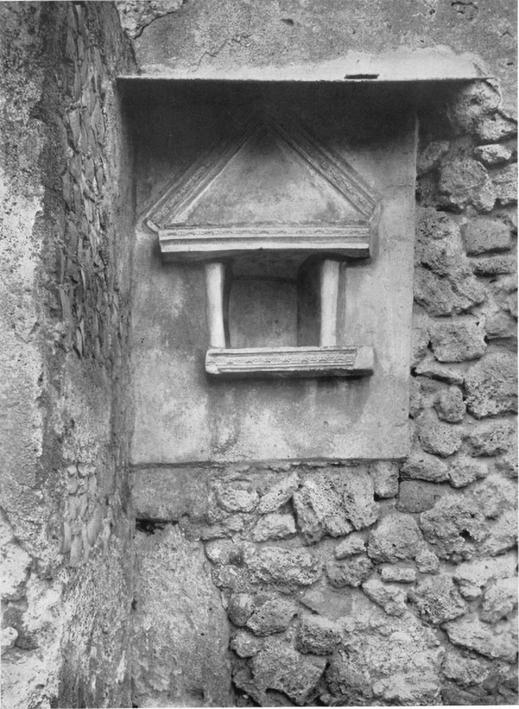 V.4.9 Pompeii. 1937 or earlier. Niche with disproportionately large pediment on north side of atrium.
See Boyce G. K., 1937. Corpus of the Lararia of Pompeii. Rome: MAAR 14. (p.41, no.123, Pl.7,1).

