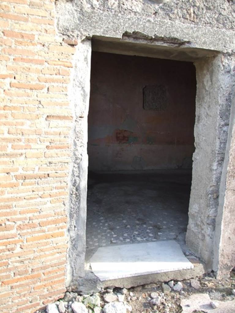 VI.1.10 Pompeii. December 2007. Doorway to room 9. Room to south of garden.  Mau identified the room at the rear, to the right of garden, with window opening onto the garden as the only room with paintings of interest:  A man sitting with a writing tablet in his hand, opposite him were 2 girls, one sitting, the other standing; the latter held a roll of papyrus, p.281, Same room, another panel, which was transferred to Naples Museum:  A young woman was represented as painting a herm of Dionysus; a cupid was holding the unfinished picture while she mixed colours on her palette. Two other maidens were watching the artist with unfeigned interest, etc , p.282, figure 133,                                       
The room contained a third picture, which is now almost obliterated.
See Mau, A., 1907, translated by Kelsey F. W. Pompeii: Its Life and Art. New York: Macmillan.  (p.280-2, T. 133).

Helbig identified:
Room to the right of the garden, God and 2 girls, 1459
Room near peristyle, Painting of Girl, 1443
Maybe in the prothyron, Bust of a Girl, 1427b
See Helbig, W., 1868. Wandgemälde der vom Vesuv verschütteten Städte Campaniens. Leipzig: Breitkopf und Härtel. (1459, 1443, 1427b).

