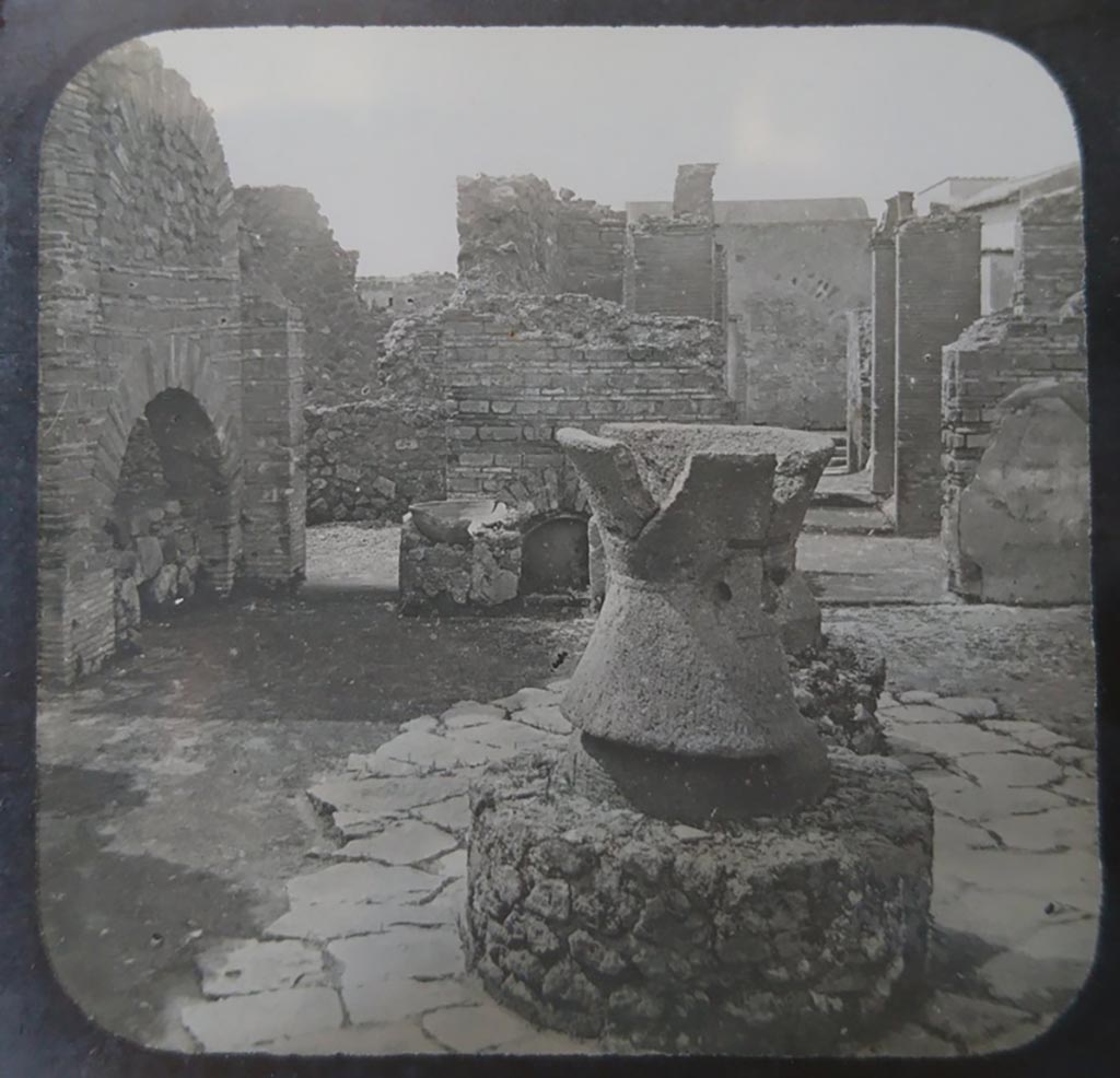 VI.3.3 Pompeii. c.1900. C. and G. Lantern slide published by A. Laverne. Room 7, looking west across bakery.  