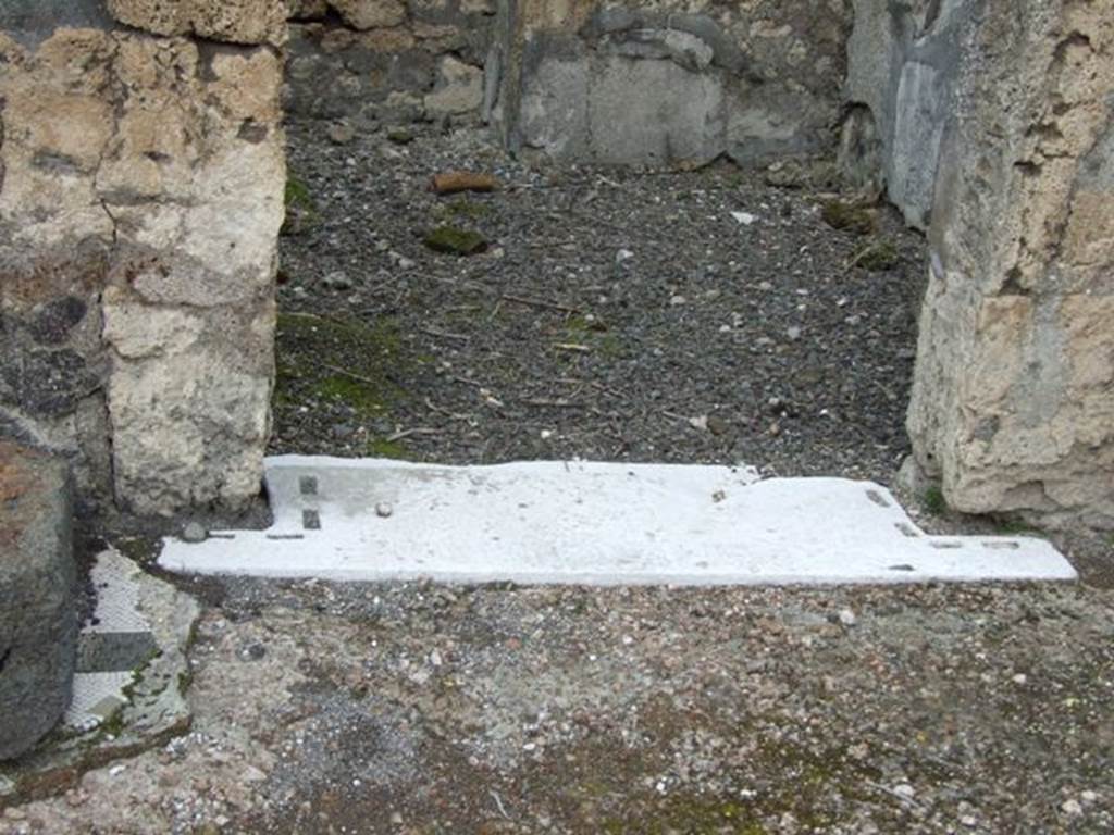 VI.10.7 Pompeii.  March 2009.  Room 6.  Marble door sill showing grooves for doors or shutters.