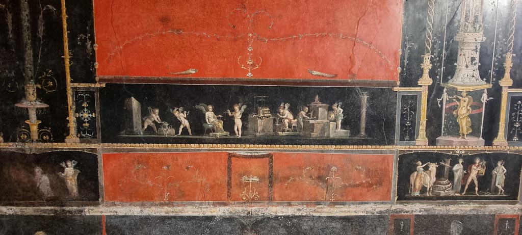 VI.15.1 Pompeii. January 2023. East wall with panel showing cupid goldsmiths. Photo courtesy of Miriam Colomer.