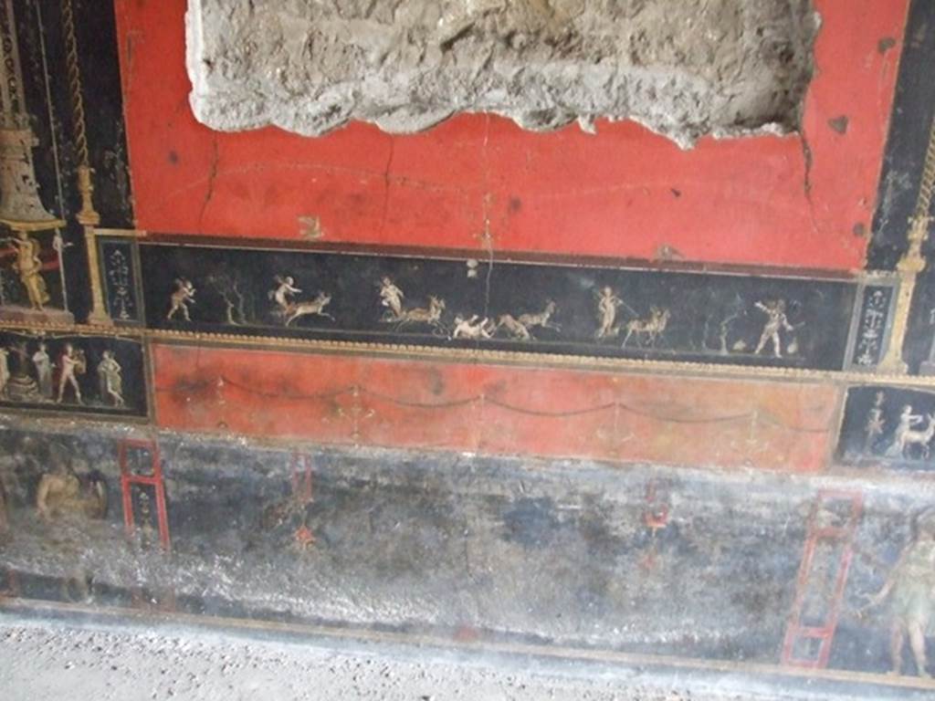 VI.15.1 Pompeii.  December 2006.  Room of the Cupids or Cherubs. East wall. Painting of Cupids in a Race between Chariots pulled by Deer.  Underneath left and right are standing figures of Amazons.

