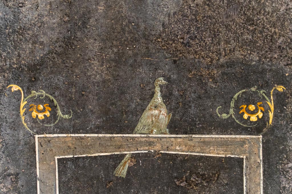 VI.15.1 Pompeii. August 2023. 
Detail of painted bird on black painted zoccolo on lower east wall at south end. Photo courtesy of Johannes Eber.
