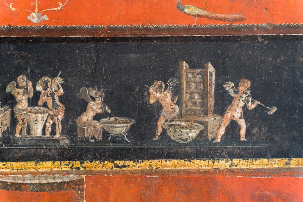 VI.15.1 Pompeii. March 2023. Lower east wall at south end, detail of cupids making perfumed oil. Photo courtesy of Johannes Eber.