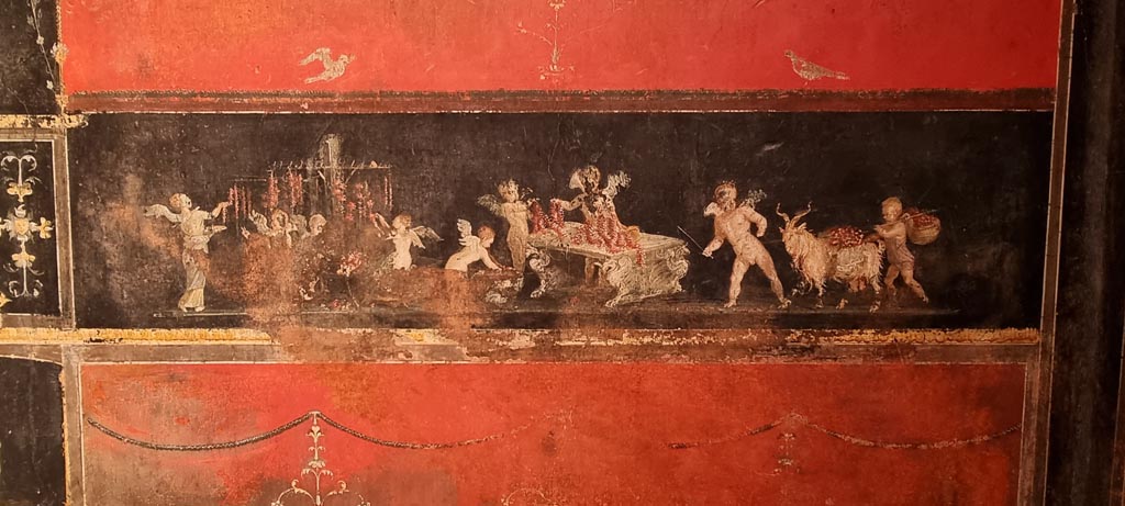 VI.15.1 Pompeii. January 2023.
East wall in the south-east corner with painting of cupids as flower dealers, picking and selling flowers and making garlands.
Photo courtesy of Miriam Colomer.
