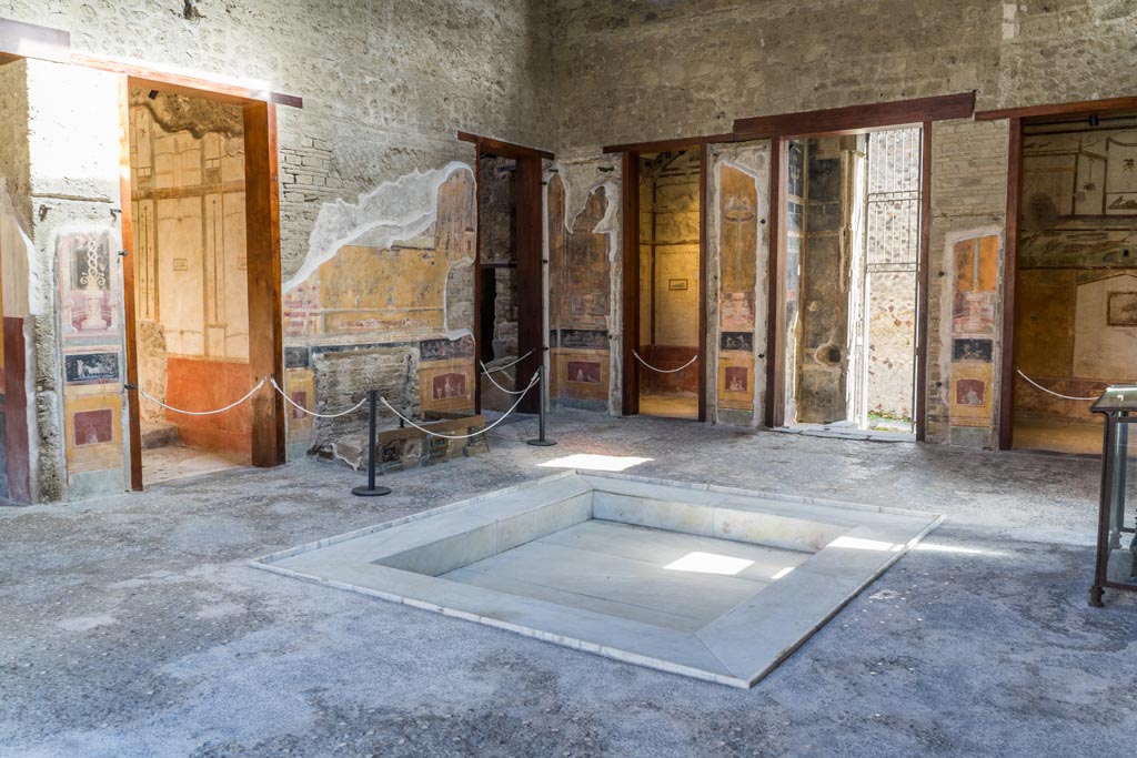 VI.15.1 Pompeii. March 2023. 
Looking north-east across atrium, with doorway to services area, centre left, and doorway to cubiculum k in north-east corner of atrium, centre right.
Photo courtesy of Johannes Eber.
