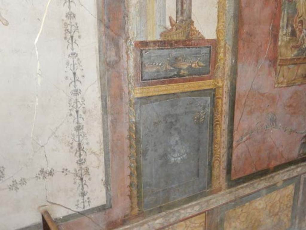 VI.15.1 Pompeii. May 2017. North wall of exedra on west side of central painting, wall painting of naval scene, with basket and mask above. Photo courtesy of Buzz Ferebee.
