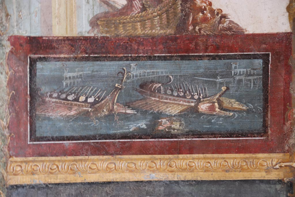 VI.15.1 Pompeii. October 2023. North wall of exedra, painted panel of naval scene. Photo courtesy of Klaus Heese.