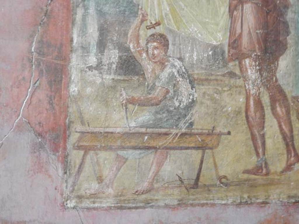 VI.15.1 Pompeii. May 2017.  Detail from central painting showing Daedalus’s helper carrying out work with hammer and chisel. Photo courtesy of Buzz Ferebee.
