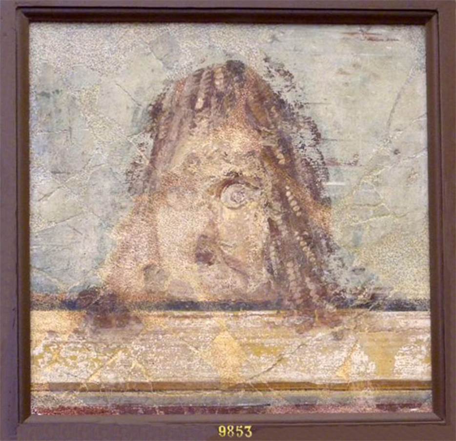 VI.17.9-10 Pompeii. Found 20-29 October 1763 or 2nd July 1763. 
Now in Naples Archaeological Museum. Inventory number 9853.
Mask found at the same time as the other two, but the colour was faded and the face was ruined by a pointed instrument.

