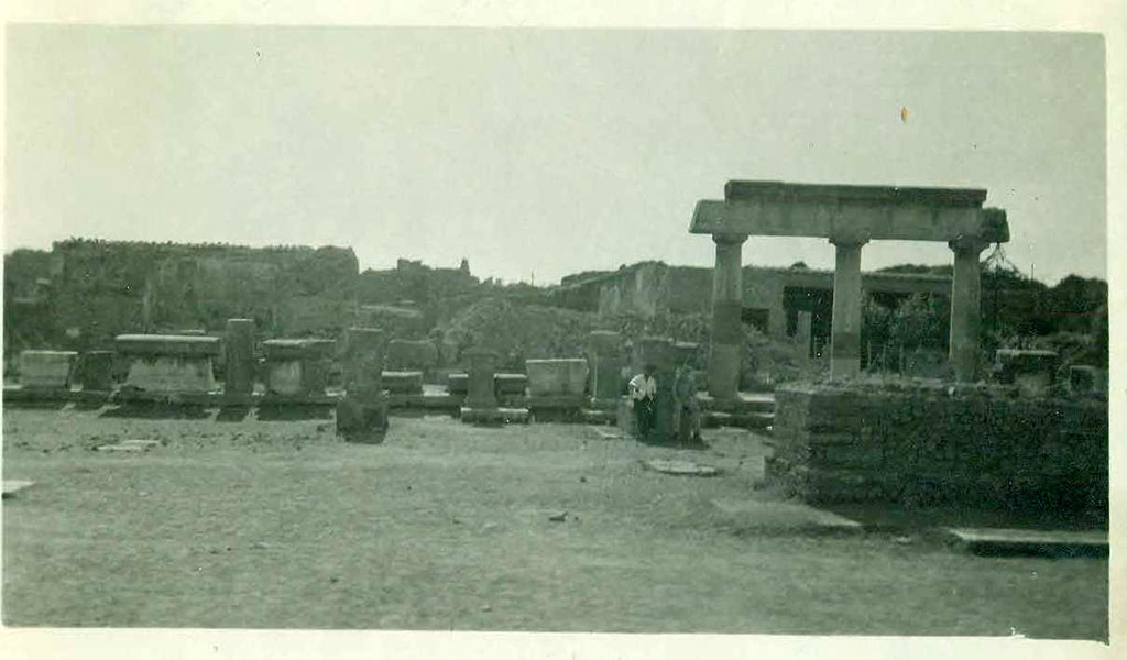 VII.8 Pompeii Forum. September 1944. Looking west across forum. Photo courtesy of Rick Bauer.
In the centre rear of the photo there appears to be a pile of rubble, presumably debris from the 1943 bombing. 
According to Garcia y Garcia, in this area, which had been reconstructed by Mauri, all the antiquities from pre-Samnite Pompeii were kept.
This area was completely destroyed by bombing in 1943 together with the rooms on its south side, part of the Temple of Apollo, known as “la sagrestia”.
However, the major loss was the destruction of the collection from the archaic period.
The area has now been restored and altered with modern modifications, and once again used as a store for archaeological materials.
See Garcia y Garcia, L., 2006. Danni di guerra a Pompei. Rome: L’Erma di Bretschneider, (p.117).

