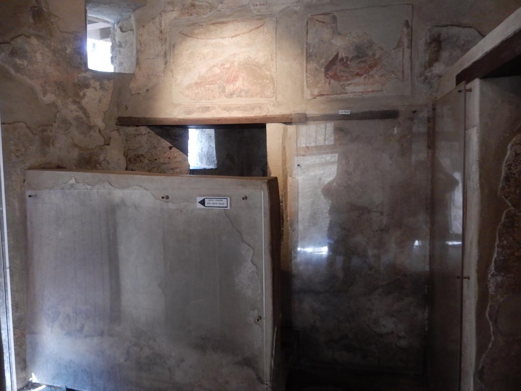 VII.12.18 Pompeii. May 2015. Doorway to the latrine at the west end, behind the screen. Photo courtesy of Buzz Ferebee.