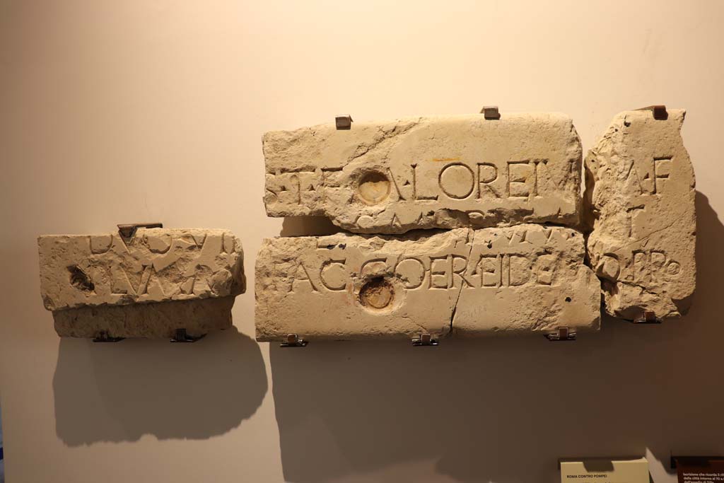 VIII.1.4 Pompeii. February 2021. 
Limestone inscription recording the rebuilding of the town walls in about 70BCE after the damages caused by Sulla’s siege, found in VII.1.40.
Photo courtesy of Fabien Bièvre-Perrin (CC BY-NC-SA).
According to Epigraphic Database Roma this and reads
It was found in VII.1.40, House of M. Caesius Blandus (or of Mars and Venus), in pieces 'some of which served for the edge of a door, and others spread on the floor of the peristyle' (aa. 1862-1868).
