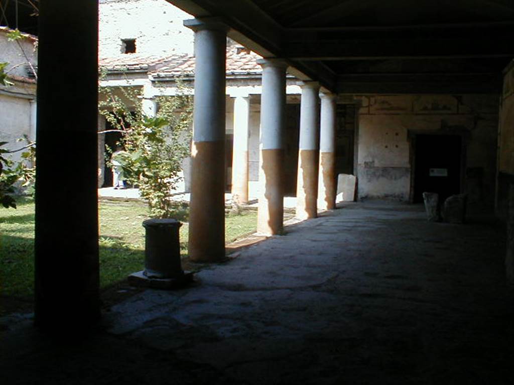 IX.13.1-3 Pompeii. September 2004. Room 9, looking north along east portico.
