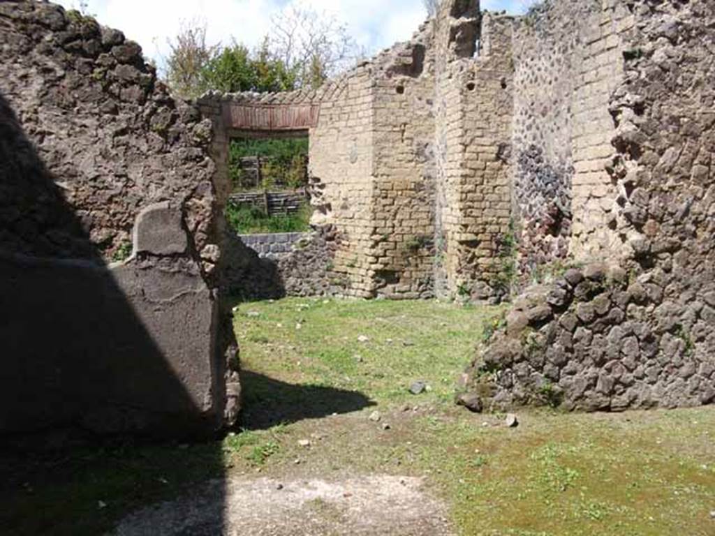 Villa of Mysteries, Pompeii. May 2010. Room 25, apsidal hall, from room 26.
Boyce said that Maiuri suggested this room of curious shape with an apse in the side opposite the entrance doorway, and four rectangular niches in the walls was undergoing renovation at the time of the eruption. Maiuri thought it may have been intended as a domestic Sacellum, and possibly would have housed the statue of Livia found nearby in the peristyle.
See Boyce G. K., 1937. Corpus of the Lararia of Pompeii. Rome: MAAR 14. (p. 98) 
See Maiuri, Villa dei Misteri, (76 and fig.29)
