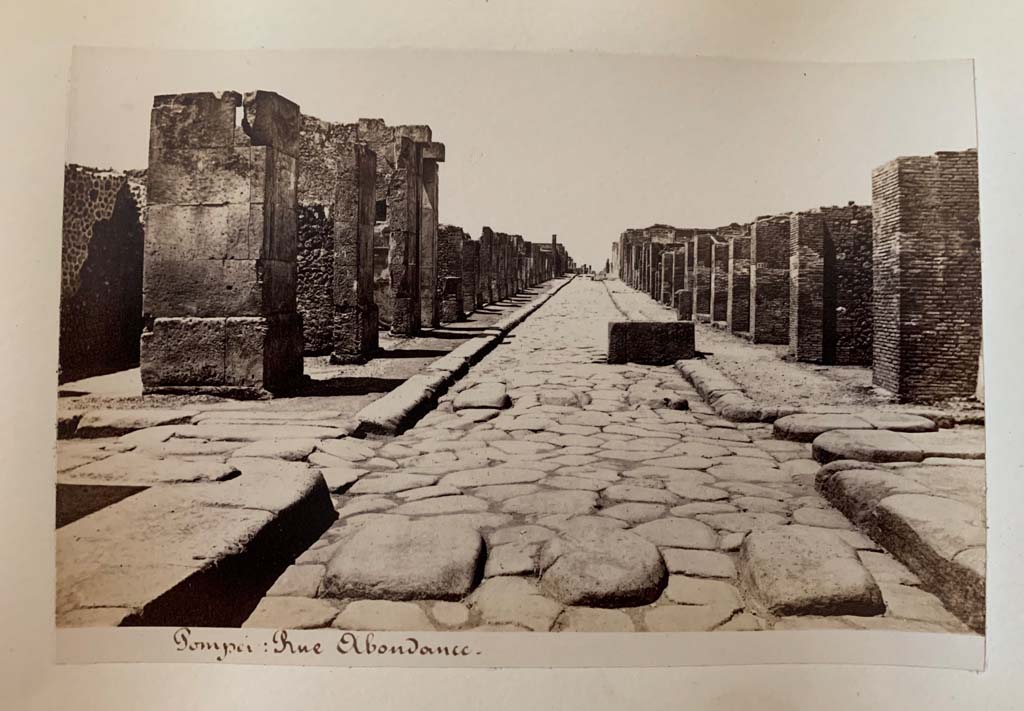 Via dell’Abbondanza. Album by M. Amodio, c.1880, entitled “Pompei, destroyed on 23 November 79, discovered in 1748”.
Looking west to crossroads with Via dei Teatri, on left, and Vicolo del Lupanare, on right.
Photo courtesy of Rick Bauer.
