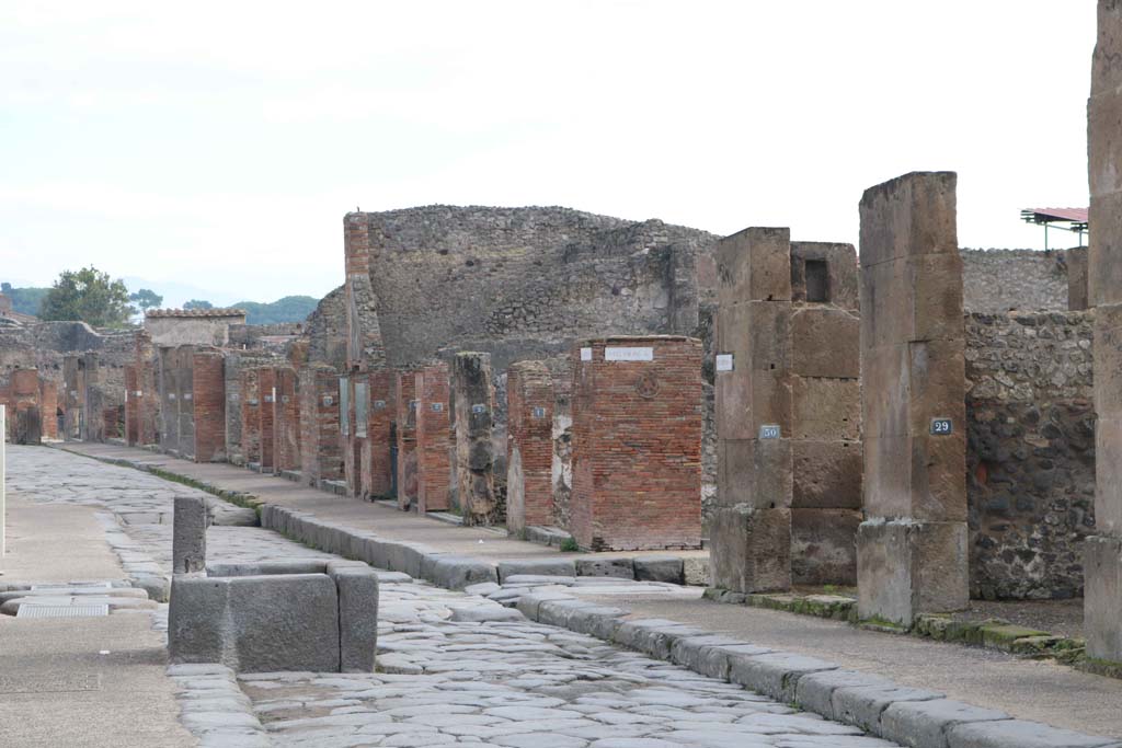 Via dell’Abbondanza, south side, Pompeii. December 2018. 
Looking east towards junction with Via dei Teatri, and Insula VIII.4, on left. From VIII.5.29, on right. Photo courtesy of Aude Durand.
