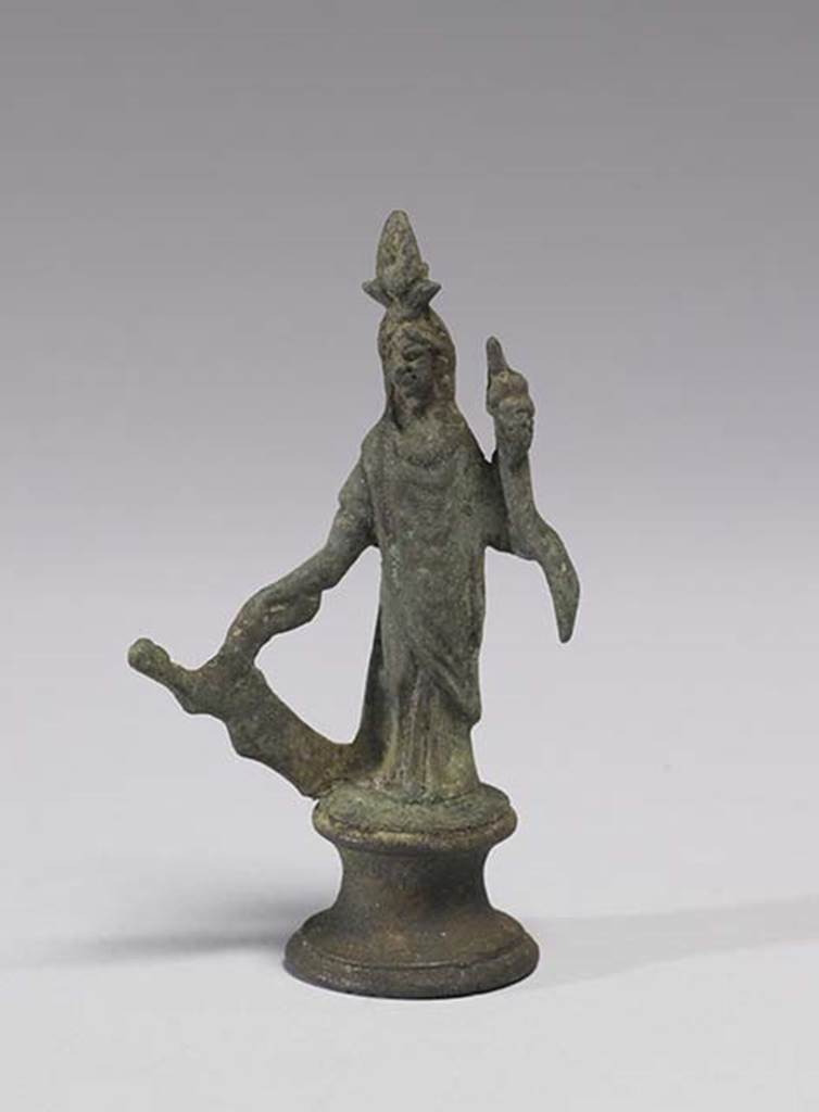 Boscoreale, Villa rustica in fondo DAcunzo. Room 12, lararium. 
Bronze statuette of Isis-Fortuna, 0.09m high including the base, front view.
She is fully clothed and has a crescent moon and a disk surmounted by two plumes upon her forehead.
In her right hand she holds a rudder, in her left hand a cornucopia.
Photo courtesy of The Walters Art Museum, Baltimore. Inventory number 54.747.
http://thewalters.org/
Creative Commons Attribution-ShareAlike 3.0 Unported Licence
