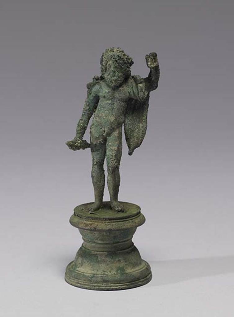 Boscoreale, Villa rustica in fondo DAcunzo.Room 12, lararium. 
Bronze statuette of standing Jupiter, 0.10m high, front view.
According to Della Corte, the statue depicted Neptune, bearded, nude except for a mantle over his left shoulder. 
In his right was possibly a dolphin, the left was raised like that of Jupiter, as if supported upon a sceptre or trident, now missing. 
Both attributes, perhaps, were made of wood.
See Notizie degli Scavi di Antichit, 1921, p. 440.
According to Stefani, the different. and more plausible interpretation proposed by others is an image of Jupiter.
See Stefani G., 2000. In Sylva Mala, Bollettino del Centro Studi Archeologici di Boscoreale, Boscotrecase e Trecase XII, p. 15 and note 44.
Photo courtesy of The Walters Art Museum, Baltimore. Inventory number 54.749.
http://thewalters.org/
Creative Commons Attribution-ShareAlike 3.0 Unported Licence
