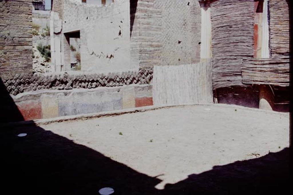 Oplontis, 1975. Area 20, the enclosed garden, looking towards the north-east corner. 
The white painted circles are the locations of the root cavities. According to Wilhelmina, “In the north-west, north-east and south-west corners a root cavity was found. There was not one found in the south-east corner as this would have blocked the entrance to the garden.” Photo by Stanley A. Jashemski.   
Source: The Wilhelmina and Stanley A. Jashemski archive in the University of Maryland Library, Special Collections (See collection page) and made available under the Creative Commons Attribution-Non Commercial License v.4. See Licence and use details. J75f0524
