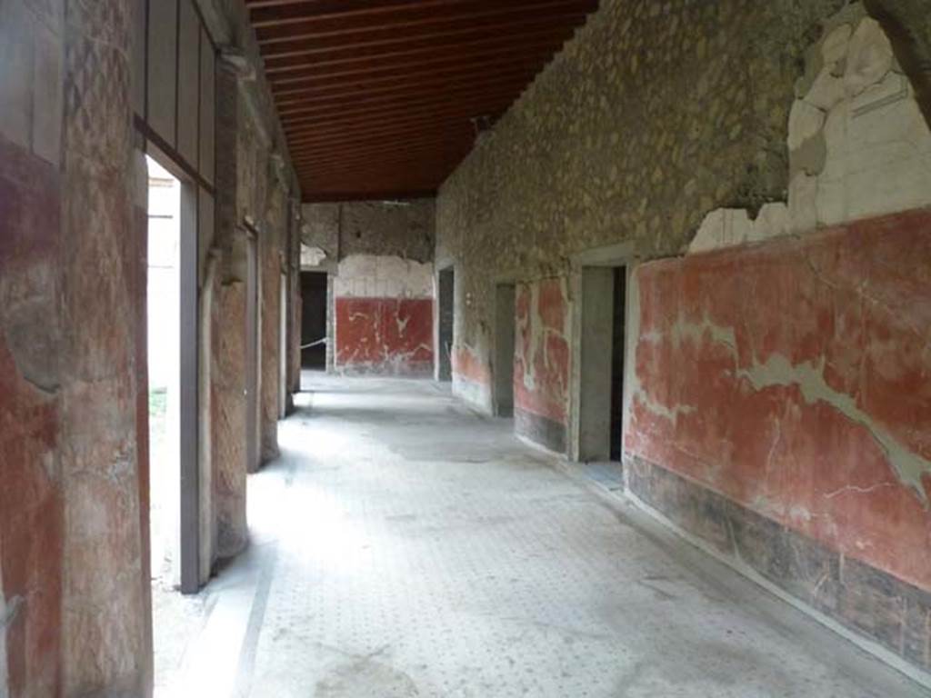 Oplontis Villa of Poppea, September 2015. Portico 24, looking west from east end.
Malandrino describes - “the southern portico with columns painted on the inside and fluted in stucco on the outside. 
The spaces between the columns were partially closed by masonry panels to protect both the porticoes themselves as well as the rooms that face onto them, from the summer heat and from the rain and the southerly winds.”
See Malandrino, C. (1978). Oplontis Villa of Poppea, (p. 72), where Room 24, is described as Room 19 on the plan).


