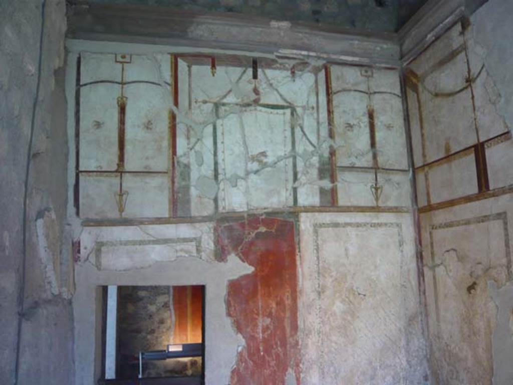 Oplontis, May 2010. Room 41, painted decoration on upper west wall of alcove. 
The small doorway leads into room 38. Photo courtesy of Buzz Ferebee. 
