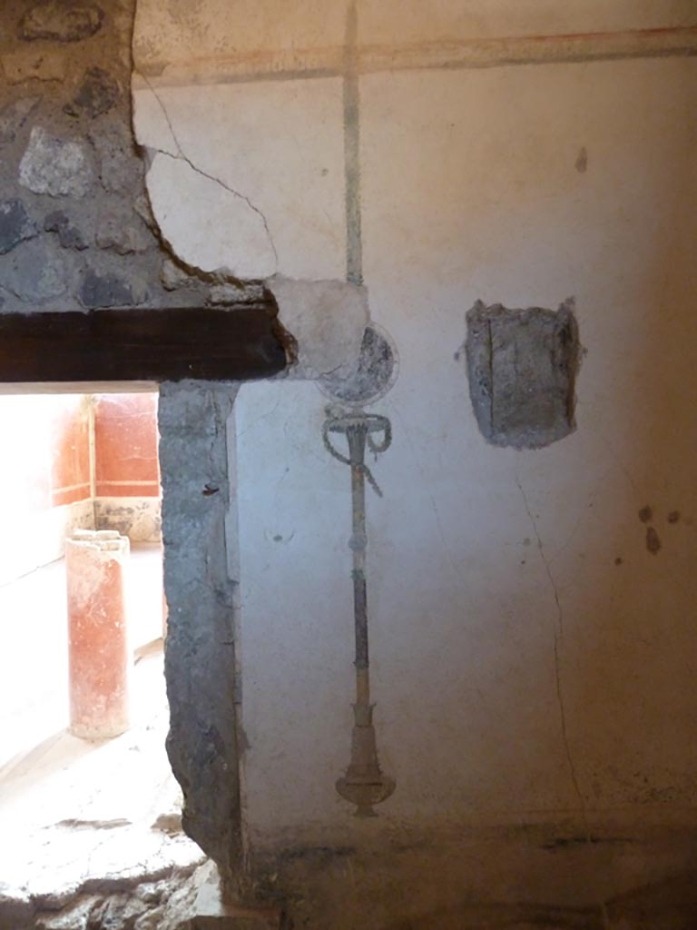 Stabiae, Villa Arianna, September 2015. 
W.28, west wall with window into small peristyle, and painted wall decoration from west wall of alcove.
