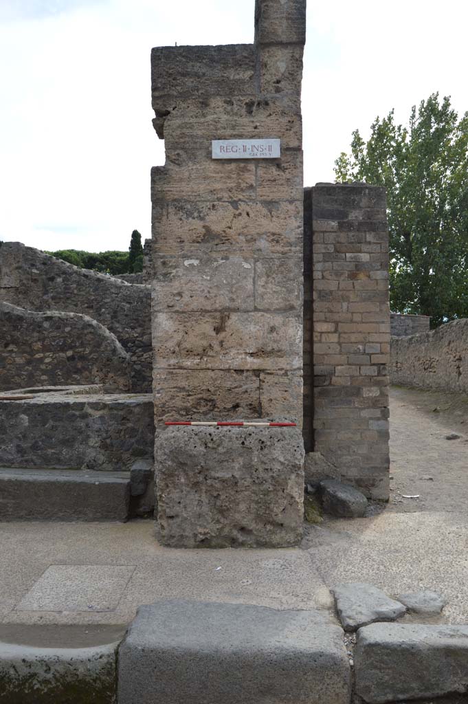 Street altar outside II.2.1 Pompeii. October 2018. 
Looking towards west side of entrance doorway, with a street altar in front of the pilaster.
Foto Taylor Lauritsen, ERC Grant 681269 D�COR.
