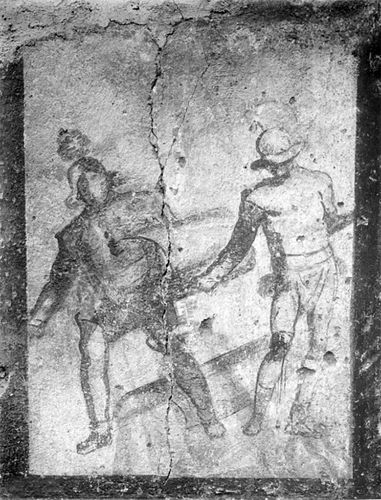 Street shrine outside IX.12.7. Detail from 1912 photograph.
Top left of the four paintings was a monochrome painting of two gladiators in combat.
According to Jacobelli, this represented the final encounter between two gladiators. 
Both were armed with curved rectangular shields, helmets and armbands. One wears high boots, the other a legging and a knee guard. 
The gladiator on the right had a bloody wound on his knee. Exhausted from combat, he was on the verge of collapse. 
The victor, probably a Thraex (Thracian), was using his shield to ward off his opponents last feeble blow.
See Jacobelli, L., 2003. Gladiators at Pompeii. Rome: L�Erma di Bretschneider. (p. 85; Figs 69-70).
