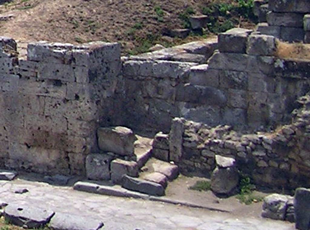 Two altars at Pompeii Vesuvian Gate. July 2003. According to Sogliano, the altars were in the south-west corner of the vestibule C, in a small recess just north of the gate stones.
One larger altar was in the wider part of the recess [d on the plan]. This would be the recess behind where the three large blocks are. Next to this altar was another much smaller altar [e on the plan], in a narrow part to the right (north) at the rear. This would be by the two small blocks with the upright stone next to them. See Notizie degli Scavi di Antichit�, 1906, p. 97-100.