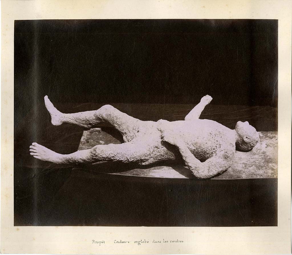Plaster-cast of victim number 6. 
In his description of this plaster-cast in his Guida di Pompei, 1877, Fiorelli described –
“Man, no.6 lying on his back, with legs spread apart, his right arm extended, and his left hand near his belt, with sandals on his feet and a ring on his finger.
From his face he would appear to be an African. (Reg. IX, insula III, via secunda).
See Fiorelli, Guida di Pompei, [Rome, 1877,] p.88-89. 
See Dwyer, E., 2010. Pompeii’s Living Statues. Ann Arbor: University of Michigan Press, (p.93).
