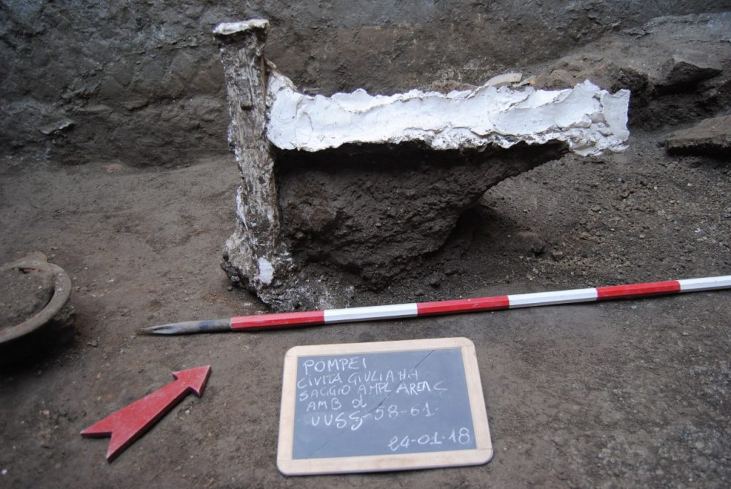 January 2018. Part of a wooden bed, a cast of which has been made.

Gennaio 2018. Parte di un letto in legno di cui è stato possibile realizzare il calco.

Photograph © Parco Archeologico di Pompei.
