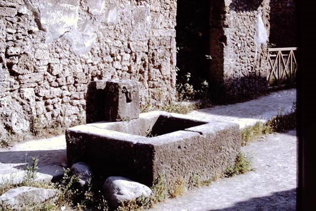 Fountain on Via dell� Abbondanza between II.1.2 and II.1.3. Pompeii, 1968. 
Photo by Stanley A. Jashemski.
Source: The Wilhelmina and Stanley A. Jashemski archive in the University of Maryland Library, Special Collections (See collection page) and made available under the Creative Commons Attribution-Non Commercial License v.4. See Licence and use details.
J68f0305
