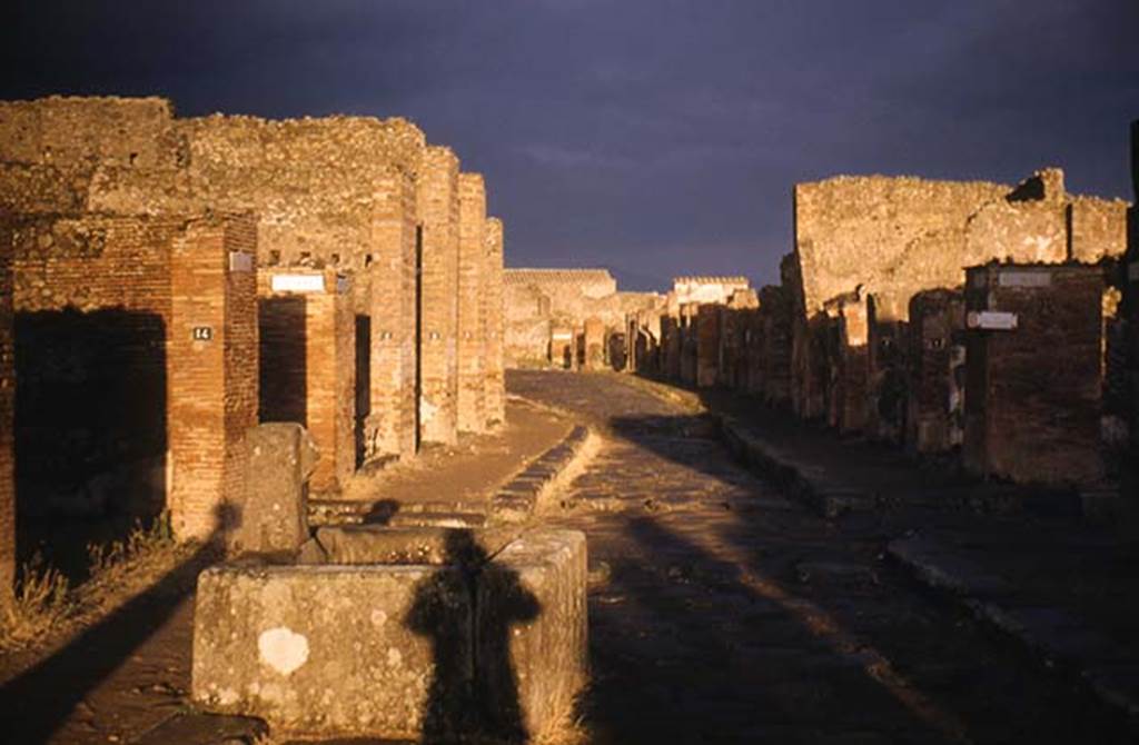 Fountain outside VII.14.13 and VII.14.14 on Via dell�Abbondanza. February 1952. Looking east towards junction with Via del Lupanare, on left, and Via dei Teatri, on right. Photo taken from near fountain at VII.14.13/14. Photo courtesy of John Vanko. His father took this photo in 1952, identical to the one above.
