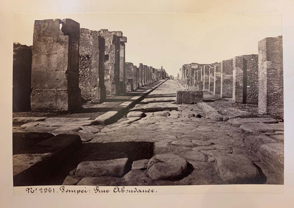 Fountain outside VII.14.13 and VII.14.14 on Via dell�Abbondanza. From an album of Michele Amodio dated 1874, entitled �Pompei, destroyed on 23 November 79, discovered in 1748�. 
Looking west to crossroads with Via dei Teatri, on left, and Vicolo del Lupanare, on right.
Photo courtesy of Rick Bauer.
