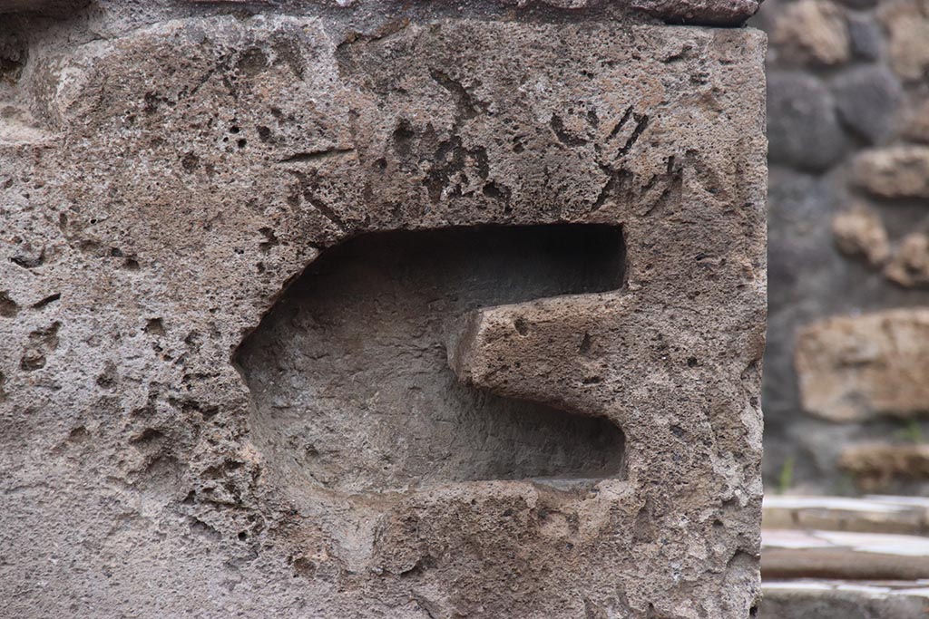 I.1.2 Pompeii, October 2024. Detail from pilaster between I.1.3, and north end of I.1.2, on right. Photo courtesy of Klaus Heese.